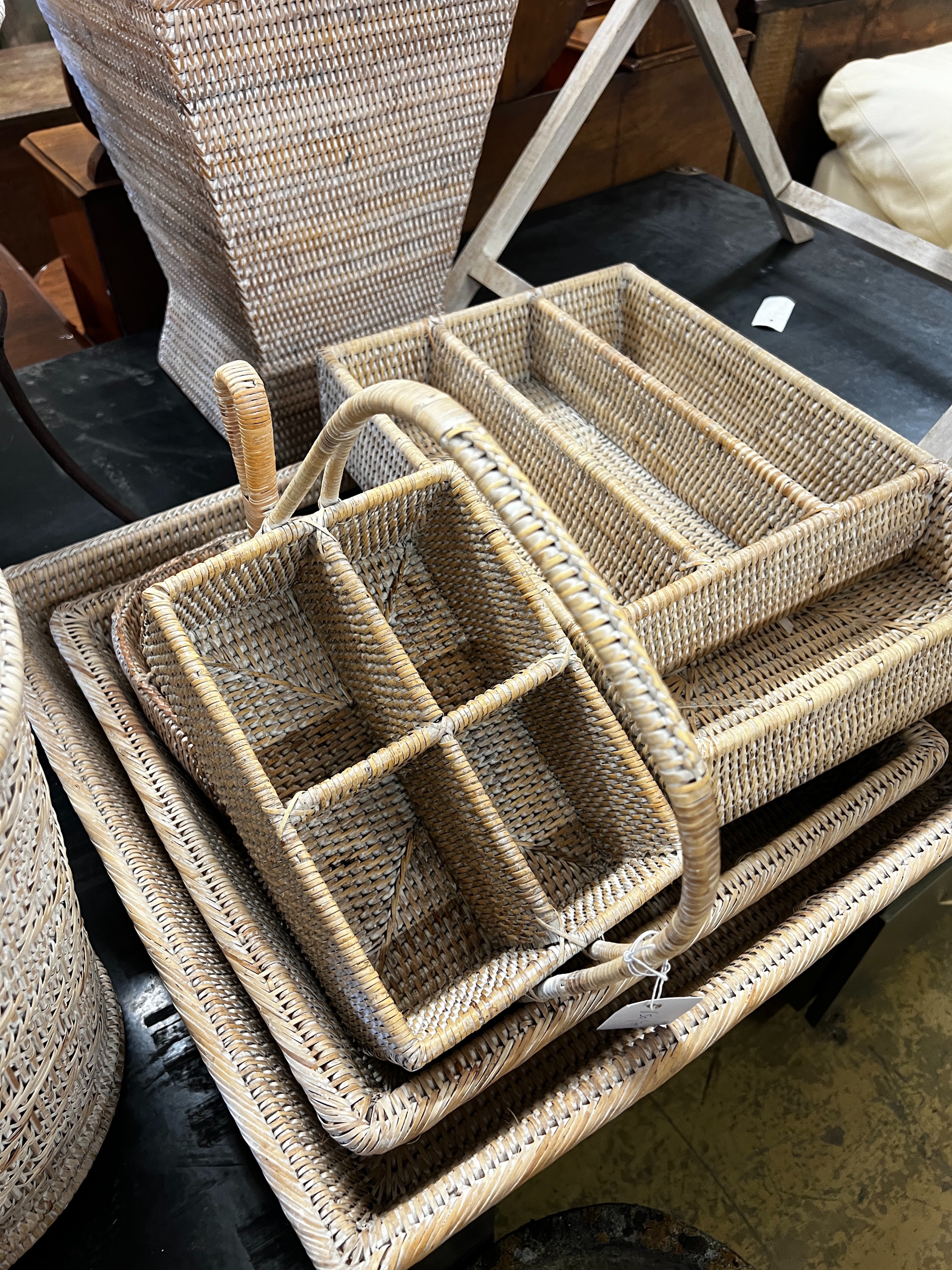 A wicker tray on folding stand together with nine other pieces of wickerwork